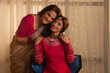 © IndiaPix - Portrait of happy mother and daughter looking at camera with smile