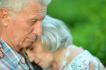 Sticker - Unhappy senior couple posing in the summer park