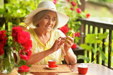 Sticker - Portrait of a happy aged woman drinking coffee