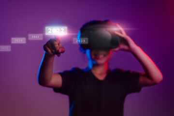 Wall Mural - Metaverse and Blockchain Technology Concepts. Person Enjoying an Experiences of metaverse virtual digital technology game control with VR glasses, GameFi, 2022