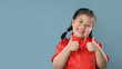 © kamon_saejueng - Smiling cute asian little girls in red chinese traditional dress.Happy Chinese new year concept.