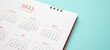 © Kwangmoozaa - 2022 calendar page on blue background business planning appointment meeting concept