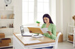 © Studio Romantic - Business correspondence. Smiling woman receive postal mail with important document, invitation or bank message. Young woman working on laptop in her home office pulls out paper document from envelope.