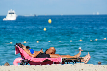 Undentified people sunbathing on sandy beach on French Riviera, Var, France