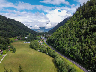 Wall Mural - Panoramic view on green Alpine spruce and pine tree forests and meadows near Saint-Gervais-les-Bains, Savoy. France