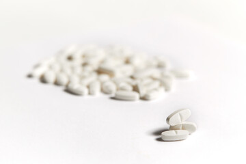 Wall Mural - White pills on the white background. Health care concept