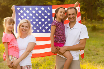 Wall Mural - Happy family in field with USA, american flag on back.