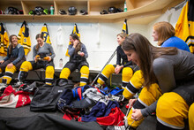 Women's Ice Hockey Team Dressing In Locker Room