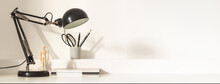 Stylish Desk, Home Office Workspace With Shadows On White Wall. Copy Space.
