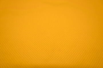 Wall Mural - Yellow football jersey clothing fabric texture sports wear background, close up. Sport Clothing Fabric Texture Background. Top View of Cloth Textile Surface. Yellow Football Shirt. 