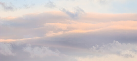 Wall Mural - Background of blue sky with white and pink clouds in sunset
