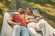 © zinkevych - A man and a woman lying in a hammock and feeling relaxed