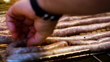 Placing Traditional Farmer's Sausage On The Grid, Ready To Barbecue