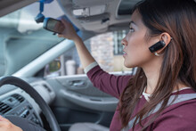 Woman With Wireless Headset Driving Car
