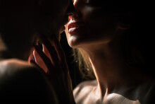 Sensual Couple In The Tender Passion. Close Up Portrait Of Woman Embracing And Going To Kiss Man. Loving Couple Kissing Over Black Background. Sexy Lips.