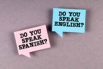 Wall Mural - Learn and speak English and Spanish. Two speech bubbles on a gray background