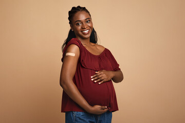 cheerful pregnant black woman got vaccinated against covid-19