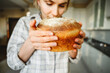 © Westend61 - Woman smelling fresh bread in kitchen at home