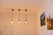 © Angelov - Vintage glowing light bulbs. Three hanging retro incandescent lamps.