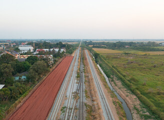 Aerial view of Thai local old classic train on railway with green mountain hills and forest trees, Thailand in public transportation concept.