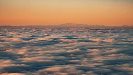 Sticker - Time lapse view of a cloud inversion at sunset viewed from the Col de Battaglia in the Balagne region of Corsica with the snow covered Alps in the distance