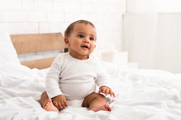 Wall Mural - Sweet African American Infant Baby Sitting In Bed Indoor