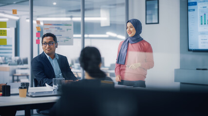 Canvas Print - Multi-Ethnic Office Conference Room. Brilliant Muslim Female CEO Wearing Hijab does Presentation for Group of Managers Talking, Using TV Infographics, Statistics. Innovative Businesspeople.