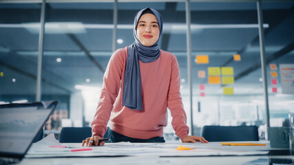 Canvas Print - Modern Office: Portrait of Muslim Businesswoman Wearing Hijab Works on Engineering Project, Does Document and Blueprints Analysis. Empowered Digital Entrepreneur Works on e-Commerce Startup Project