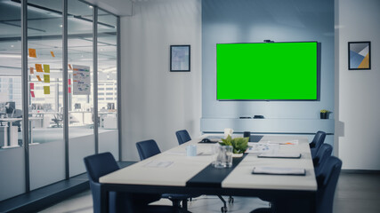 Aufkleber - Modern Empty Meeting Room with Big Conference Table with Various Documents and Laptops on it, on the Wall Big TV with Green Chroma Key Screen. Contemporary Scandinavian Style Designed Work Environment