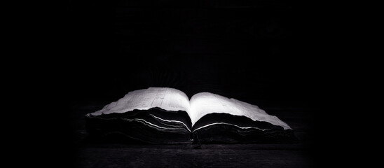 Wall Mural - Old book. Open Bible. Antique book, on a dark background.