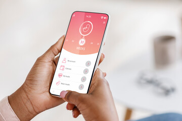 pregnant african american woman showing mobile application for pregnancy