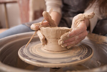 Close Up Of Female Hands Of An Artist Making Ceramic Bowl On Potters Wheel