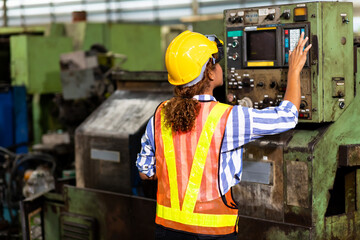 Wall Mural - African American engineer Woman wearing safety goggles control lathe machine to drill components. Metal lathe industrial manufacturing factory. Engineer Operating  lathe Machinery