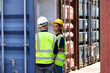 © NVB Stocker - Hispanic Man worker and woman Supervisor dock cargo checking and control loading Containers box at container yard port of import and export goods. Unity and teamwork concept