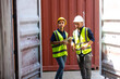 © NVB Stocker - Hispanic Man worker and woman Supervisor dock cargo checking and control loading Containers box at container yard port of import and export goods. Unity and teamwork concept