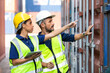 © NVB Stocker - Hispanic Man worker and woman Supervisor dock cargo checking and control loading Containers box at container yard port of import and export goods. Unity and teamwork concept