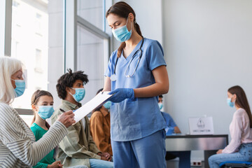 Senior Patient Lady Signing Papers With Doctor In Hospital