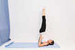 © Roman Akimov - Young woman in yoga class doing shoulder stand
