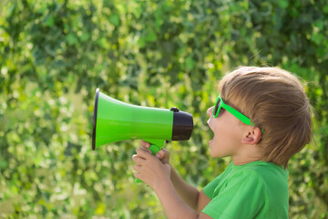 Canvas Print - Child shouting through loudspeaker in spring park