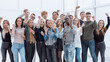 © ASDF - large group of happy young people showing their success