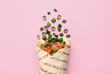 Tasty burrito on pink background