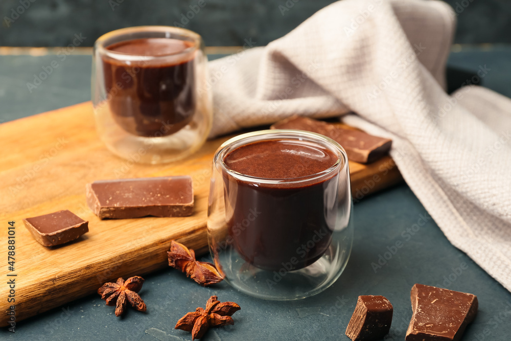 Glasses of natural hot chocolate on black background