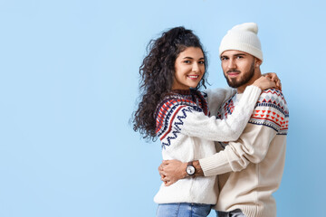 Sticker - Happy young couple in warm sweaters on color background