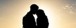 © Davide Zanin - Horizontal banner with silhouette of young hipster travelling couple wearing vintage backpack standing at the beautiful sunset - Love concept and youth culture