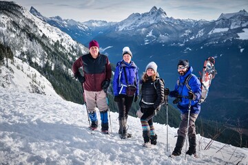 Wall Mural - Group of people showshoeing in mountains. Elk Mountain. Chilliwack. British Columbia. Canada