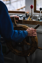 Hand Of The Captain On The Ship Steering Wheel