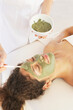 © Trinette Reed/Stocksy - Woman receiving a mud mask facial at luxury spa