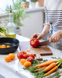 © Pietro Karras/Stocksy - Cutting vegetables on a kitchen