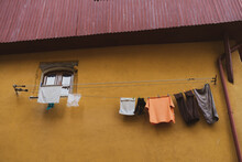 Laundry Hanging From Facade In Old House