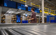 © Raymond Forbes LLC/Stocksy - Modern warehouse with conveyor belt line